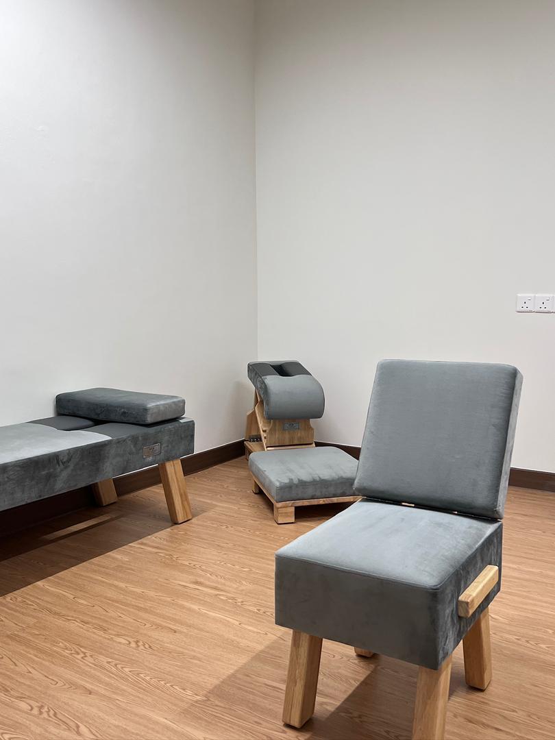 Private consultation room with seating and treatment benches