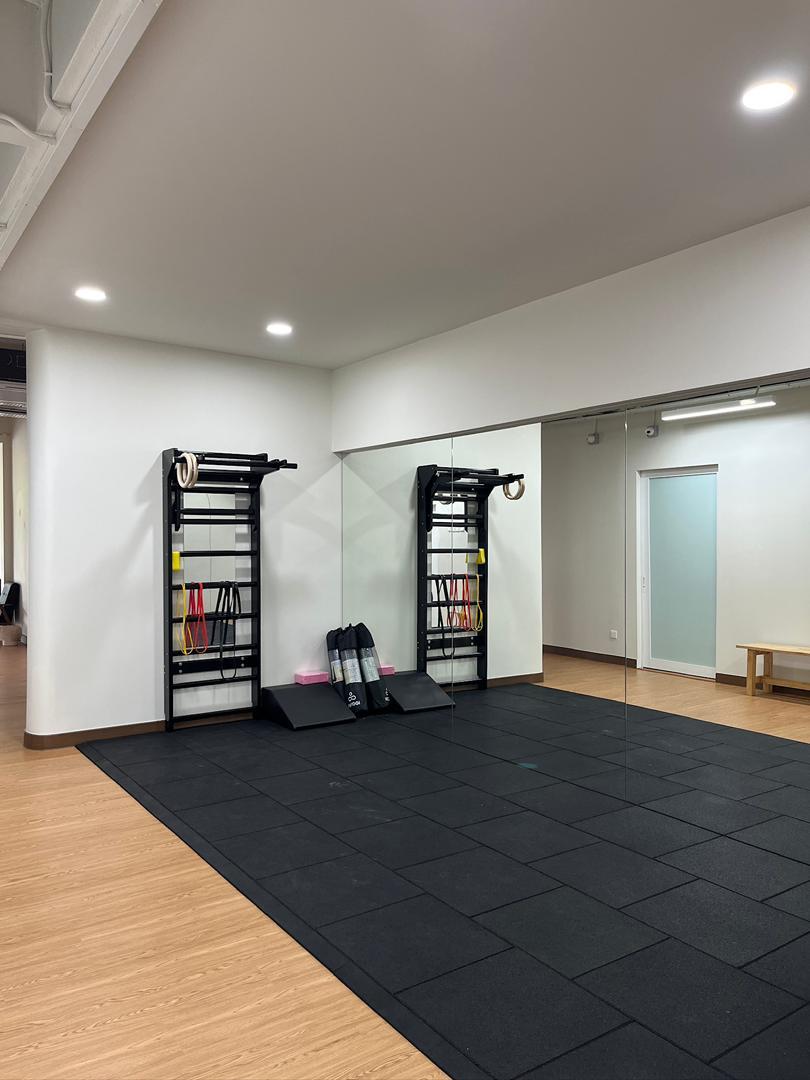 Open rehabilitation studio with mirrors and exercise equipment